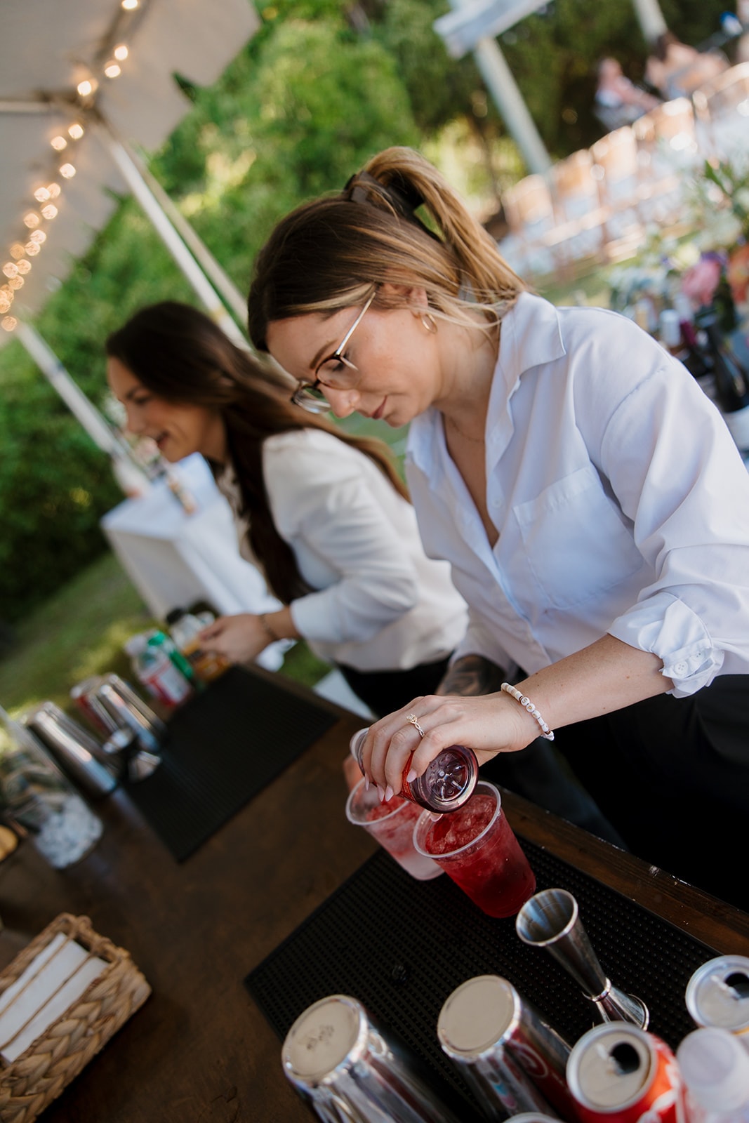 Calm Your Soul bartender shaking a cocktail at a wedding